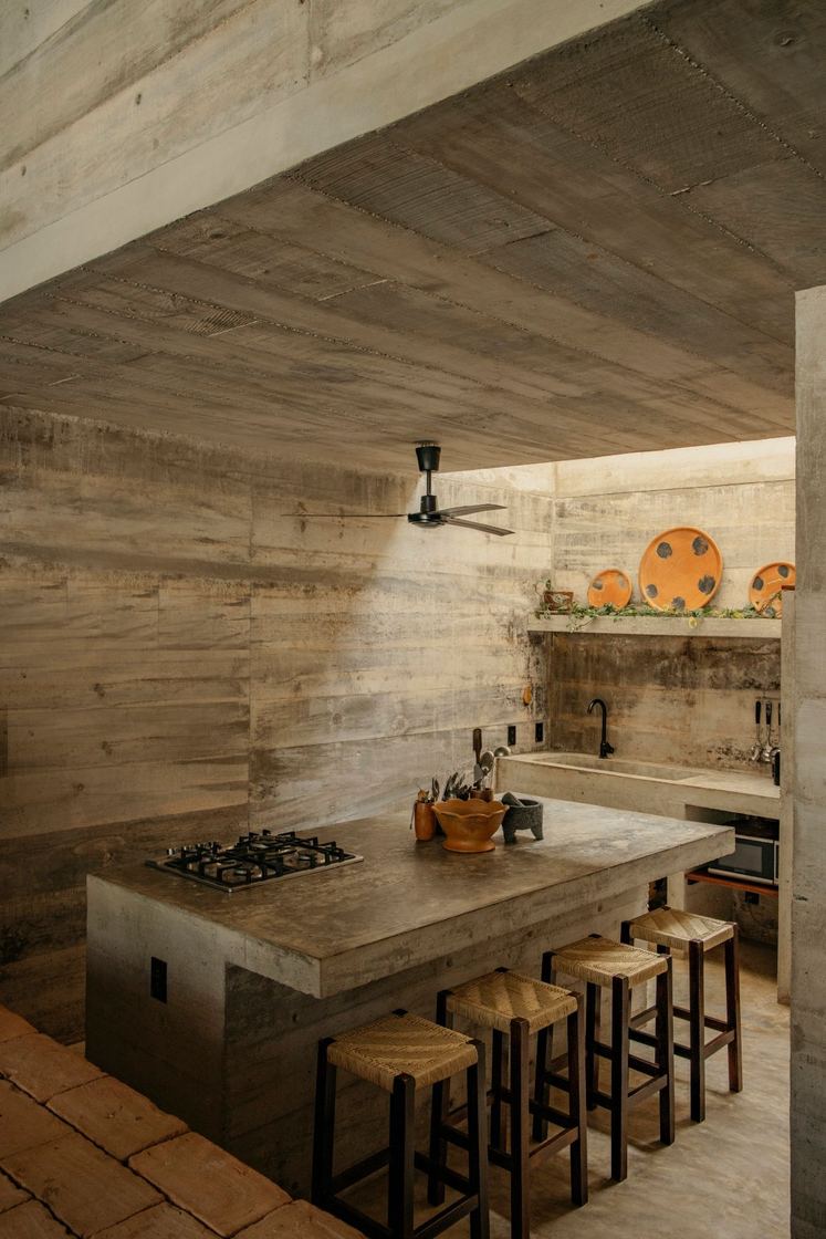 Concrete kitchen island with wooden stools