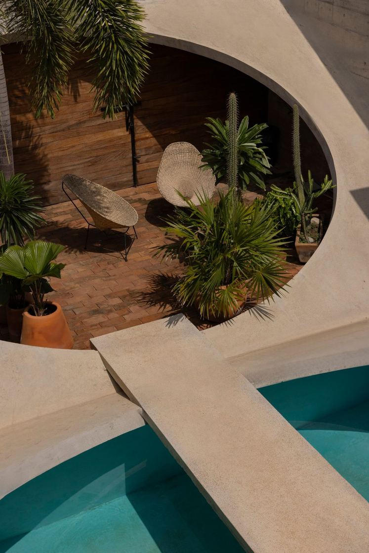 Planted garden inside the oval opening, seen across the pool